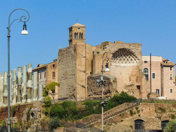 Low angle view of old building against clear blue sky