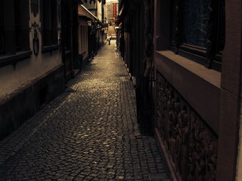 Walkway amidst buildings in city