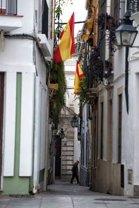 People walking on street amidst buildings in city