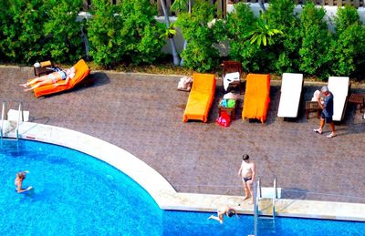 High angle view of people at poolside in hotel