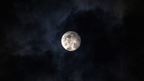 Low angle view of moon against sky at night