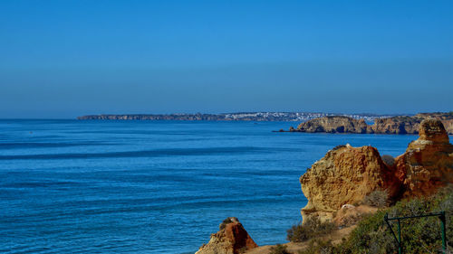 Scenic view of sea against blue sky