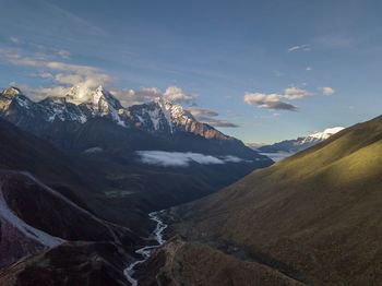 Scenic view of snowcapped mountains against sky