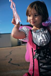 Happy girl standing against sky