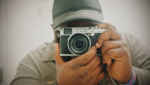 Close-up of man photographing through camera