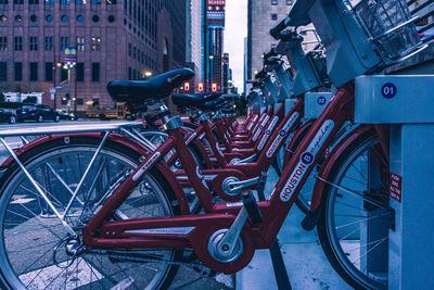 Bicycle parked on street against buildings in city