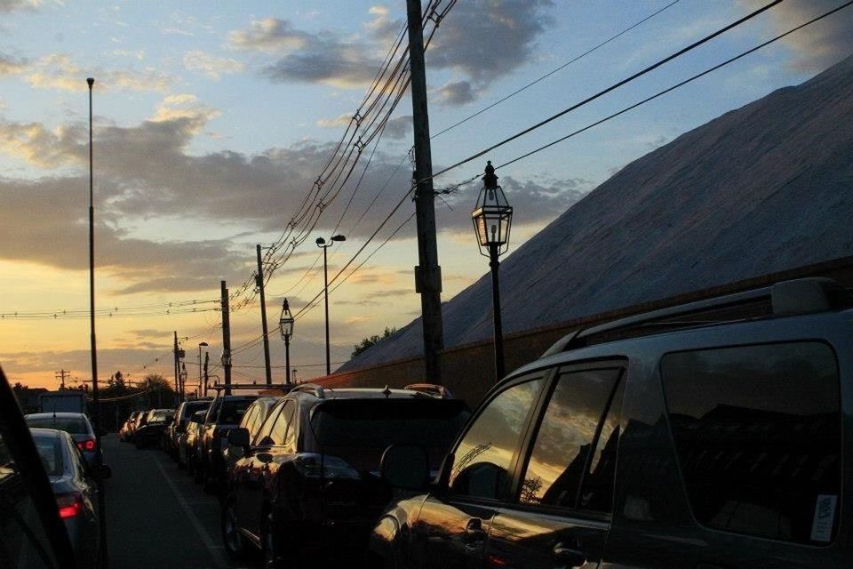 transportation, mode of transport, car, land vehicle, sky, sunset, cloud - sky, travel, power line, road, electricity pylon, on the move, cable, street, vehicle interior, street light, nautical vessel, cloud, journey, connection