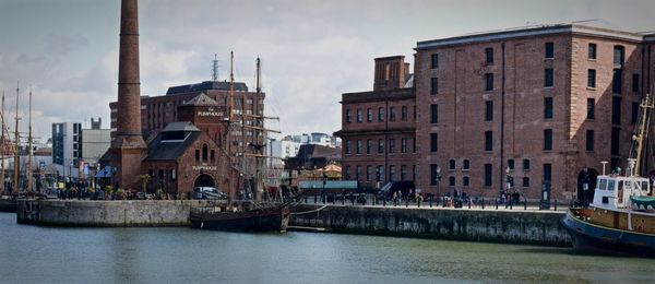 Boats in river with buildings in background