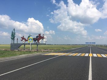 Horse cart on road against sky