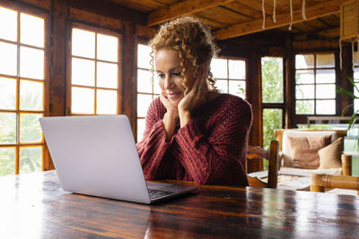 Businesswoman using laptop at table