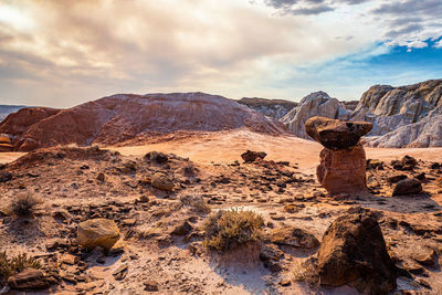 View of rock formations against cloudy sky