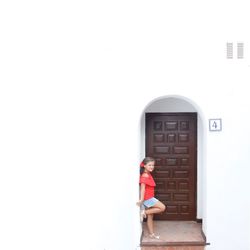 Boy on floor against white wall