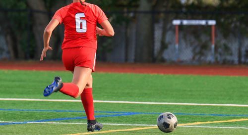 Midsection of man playing soccer