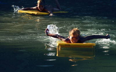 Friends floating on water at water park