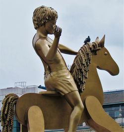 Low angle view of statue against sky