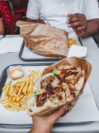 Midsection of person holding doner kebab bread