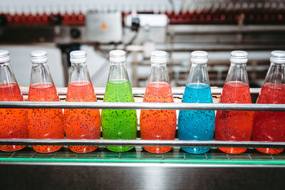 Close-up of multi colored bottles on table