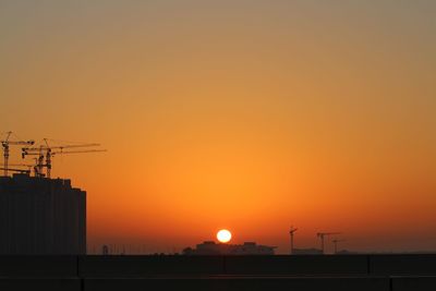 Silhouette of building against sky during sunset
