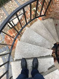 Low section of person standing on staircase