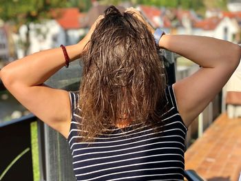 Rear view of woman standing at camera