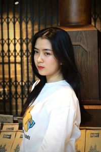 Portrait of beautiful young woman standing indoors