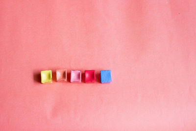 High angle view of art and craft equipment over peach background