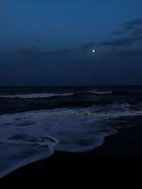 Scenic view of sea against sky at night