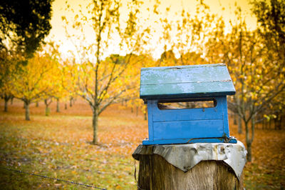 Wooden post on field during autumn