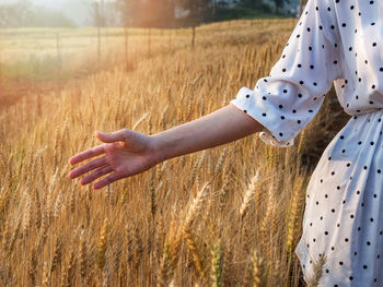 Midsection of woman on field