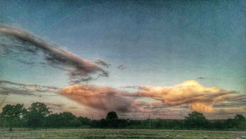 Scenic view of landscape against cloudy sky