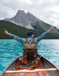 Rear view of man in boat in lake