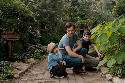 Adventurous family inspecting tropical gallery in botanical garden. local travel