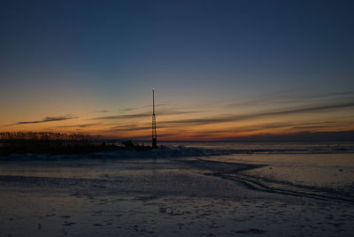 Scenic view of beach against sky during sunset