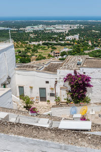 High angle view of buildings by sea against sky