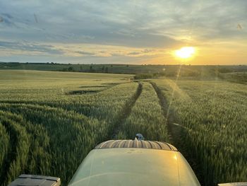 Scenic view of field against sky during sunset