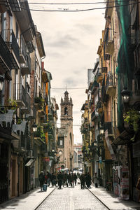 Street amidst buildings in city against sky