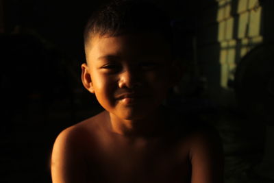 Portrait of shirtless boy at home