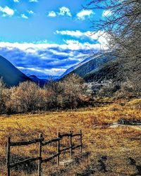 Scenic view of field against cloudy sky