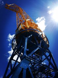 Low angle view of crane against sky