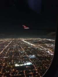 Aerial view of city against sky seen from airplane window