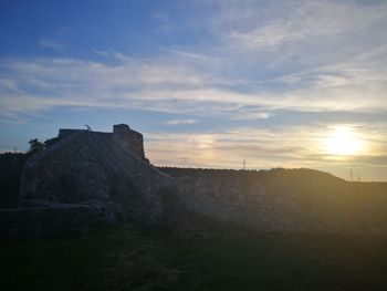 Scenic view of field against sky during sunset