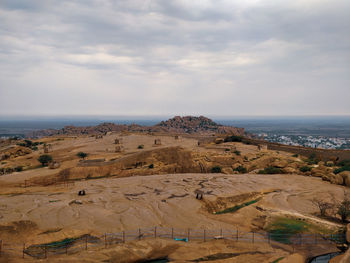 Scenic view of mountains against cloudy sky