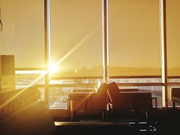 Sun streaming in office through windows during sunset