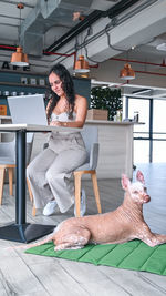 Side view of young woman exercising in gym