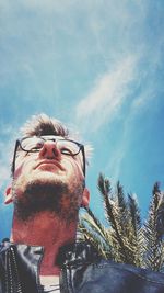 Low angle view of mature man wearing eyeglasses against sky