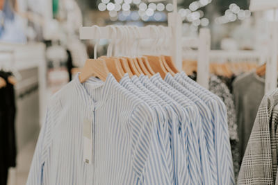 Women's blue and white striped shirts hanging on a hanger.