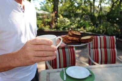 Midsection of man preparing food on table