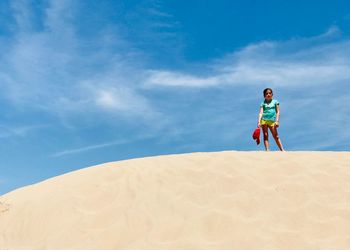 Man standing on beach against sky