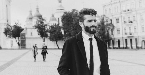 Full length portrait of young man in city