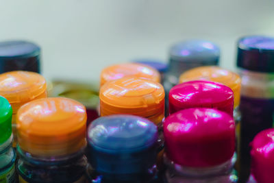 Close-up of multi colored bottles on table